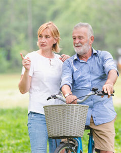 Couple on bikes looking left