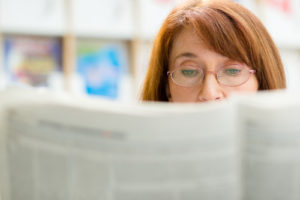 Person reading newspaper