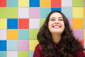Person smiling against a tiled background