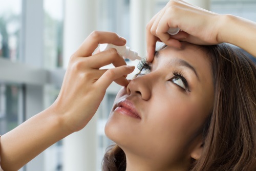 Woman Applying Eye Drops