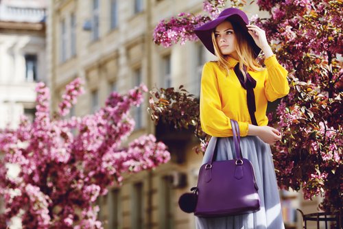 Young woman standing in front of purple trees