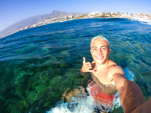 man taking selfie in water