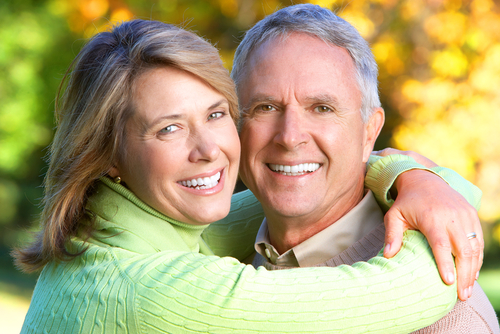 older man and woman smiling for photo