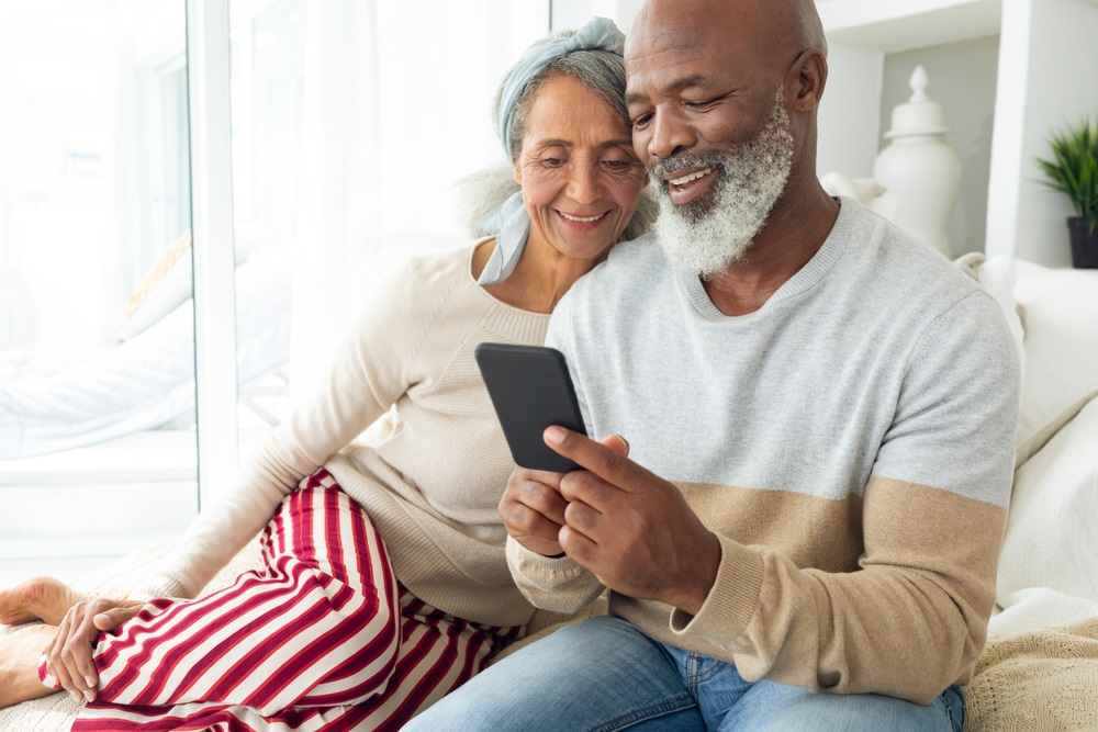 Man showing phone to woman