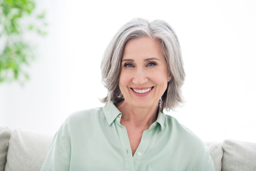 woman smiling while sitting on couch