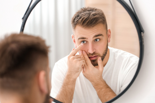 man putting in contact lenses